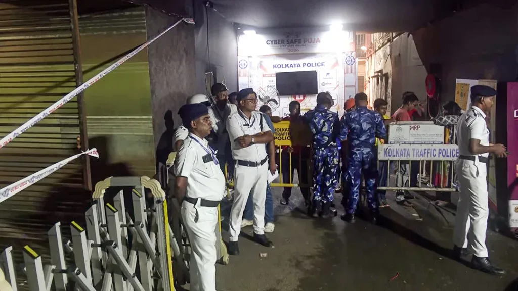 Security personnel present as a forensic team inspects the aftermath of the Chorbagan Durga Puja pandal stampede, in Kolkata on Saturday.