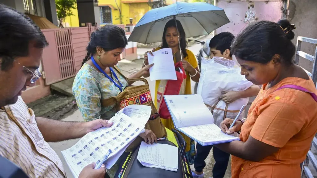 Booth level officers distributing enumeration forms to voters at West Bengal.