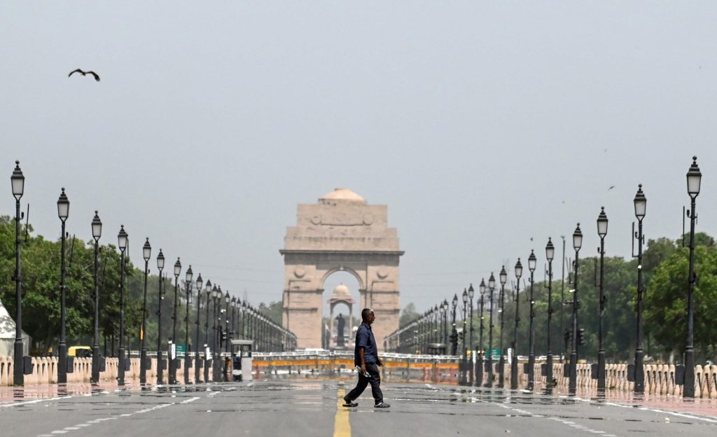 A man walks past the mirages seen at Kartavya Path on a hot summer day, in New Delhi | File image/ANI