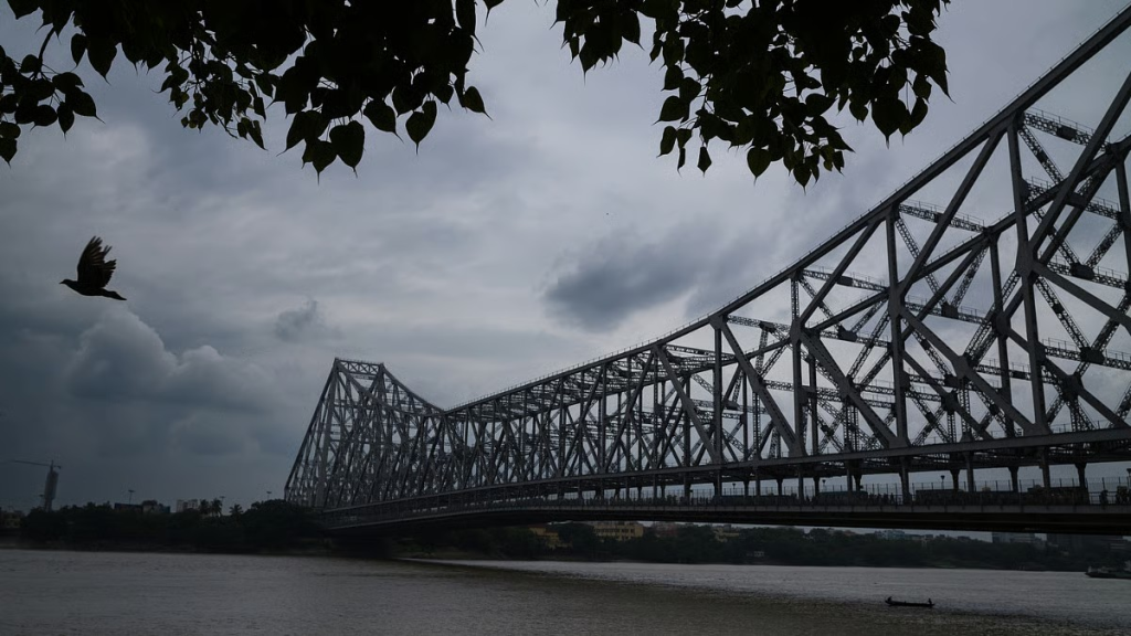 Howrah Bridge under dark monsoon clouds in Kolkata