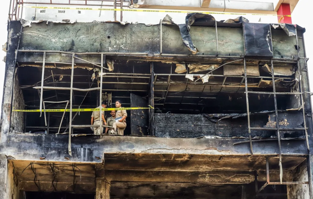 Police personnel deployed as a joint team comprising the FSL and SIT inspect the spot where a massive fire resulted in the death of 15 people | File image/ANI