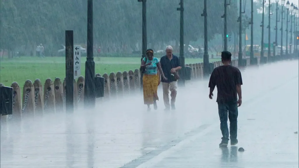 People walk at kartavya path amid rain