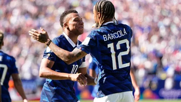 France's Kylian Mbappe celebrates a goal with Bradley Barcola