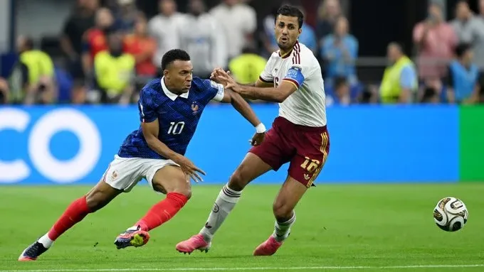 Rodri winning the ball from France's Kylian Mbappe during the semifinal of FIFA World Cup