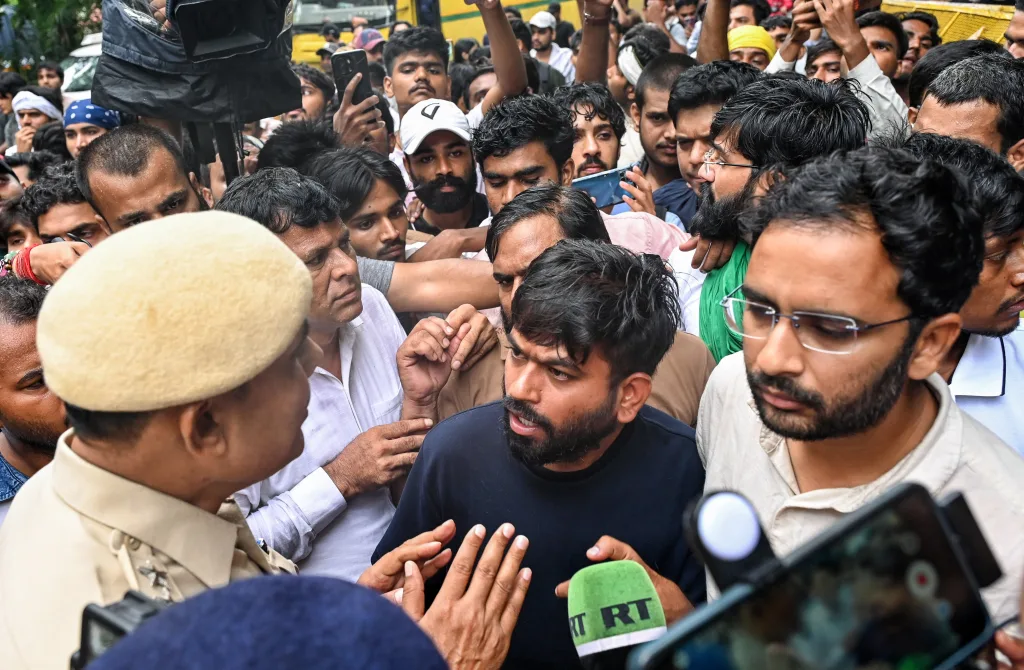 Cockroach Janta Party (CJP) founder Abhijeet Dipke speaks with a police personnel as protestors gather at the CJP protest site at Jantar Mantar, in New Delhi on Tuesday. Party spokesperson Ashutosh Ranka also present / ANI
