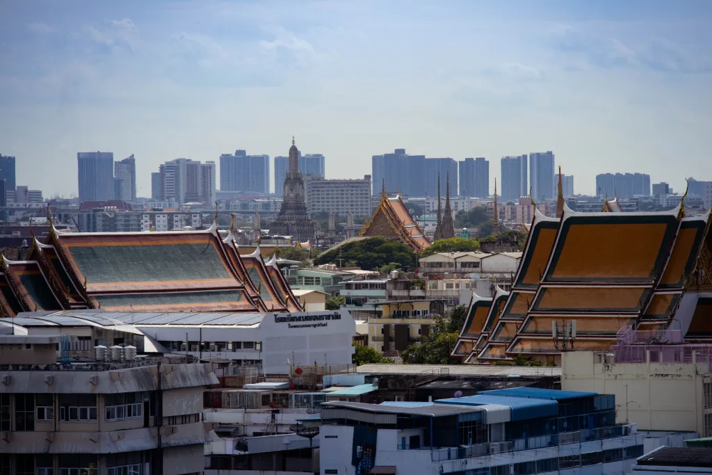 Bangkok highlighting traditional Thai architecture amidst modern buildings / Pexels