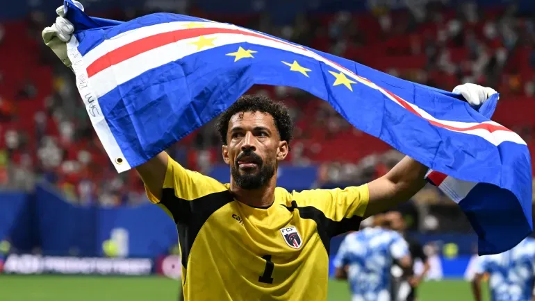 Vozinha waves the Cape Verde flag after their 0-0 draw with Spain at the FIFA World Cup